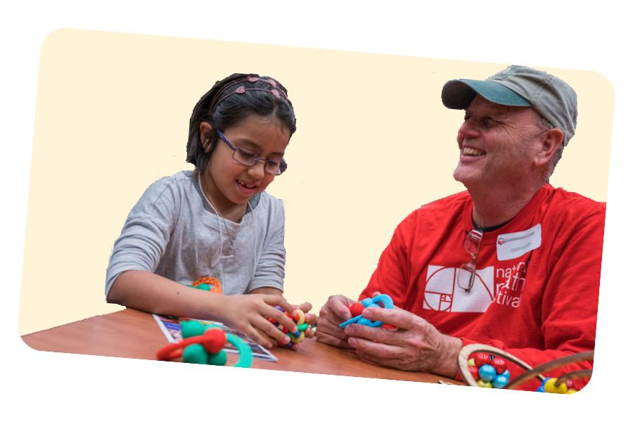 Older man laughs while playing math game with kid