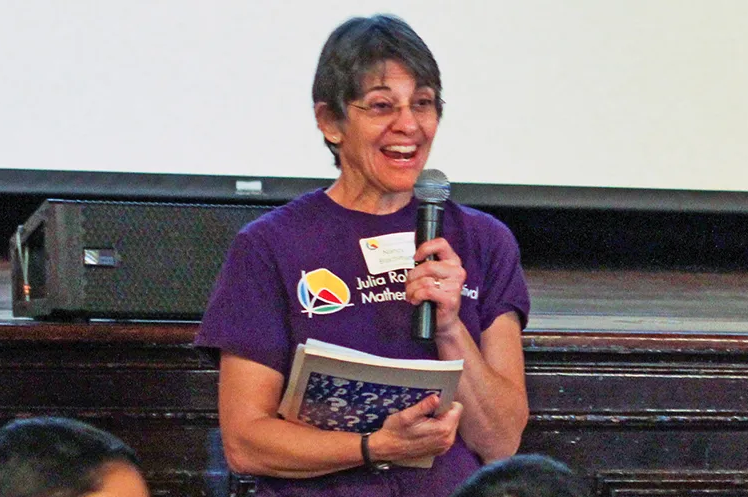 Nancy Blachman holds microphone