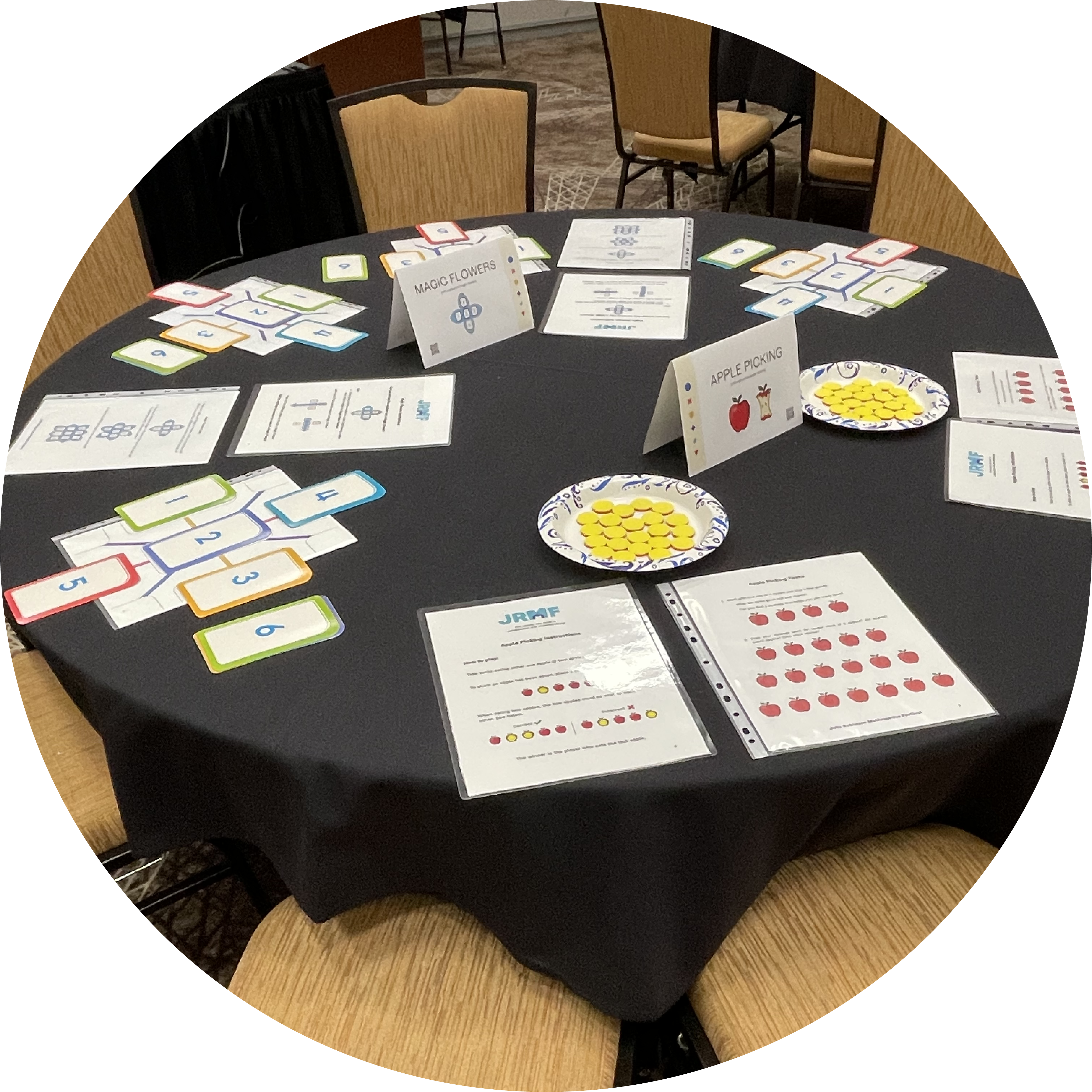 Table of math festival activities including handouts, number cards, and counters